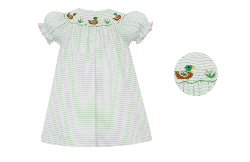 White dress with green stripes and pink trim. embroidered duck design on a white background