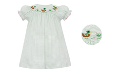 White dress with green stripes and pink trim. embroidered duck design on a white background