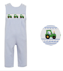 Striped overalls with tractor design and matching ball on a white background