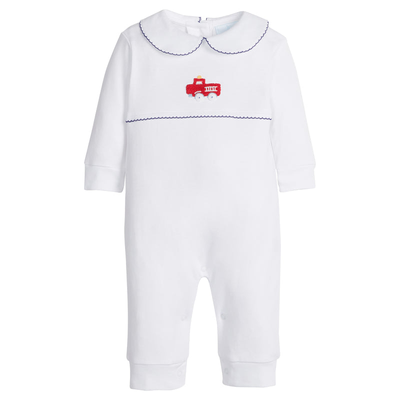 White baby romper with red firetruck design and navy trim on a white background.