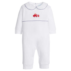 White baby romper with red firetruck design and navy trim on a white background.