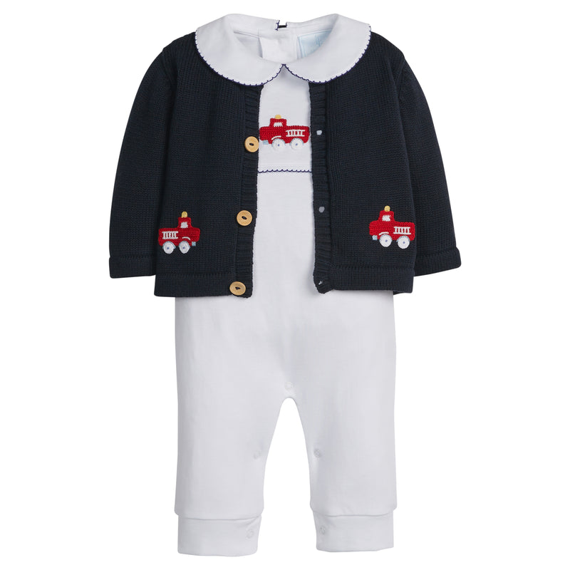 Firetruck baby kids outfit with navy firetruck cardigan, white jumpsuit with red firetruck design on a white background.