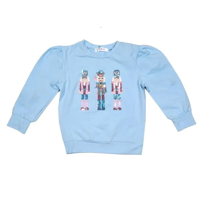 Light blue sweatshirt with sequin nutcracker design on a white background