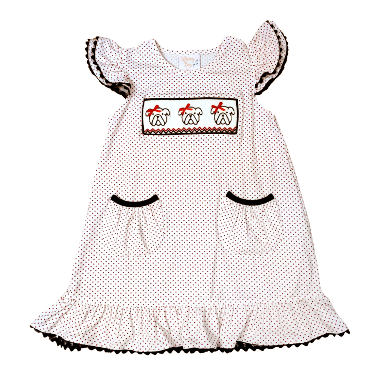 smocked bulldog kids outfit for football season. White dress with black polka dots and embroidered details on a white background