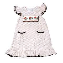 smocked bulldog kids outfit for football season. White dress with black polka dots and embroidered details on a white background