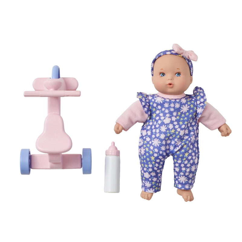 Baby doll with floral outfit, toy stroller, and bottle on a white background